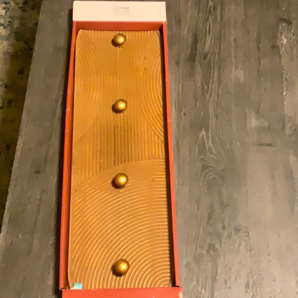 this is a goldish brown, unopened purse hanger.